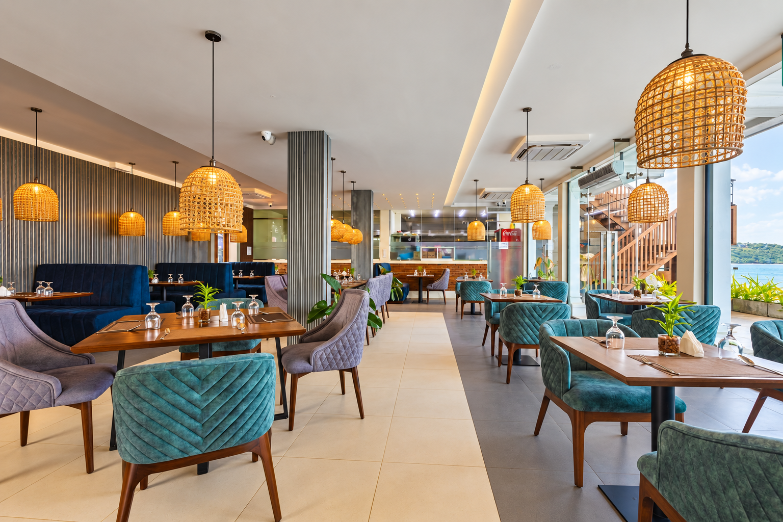 Bright Madeena dining room with woven lights and blue seating
